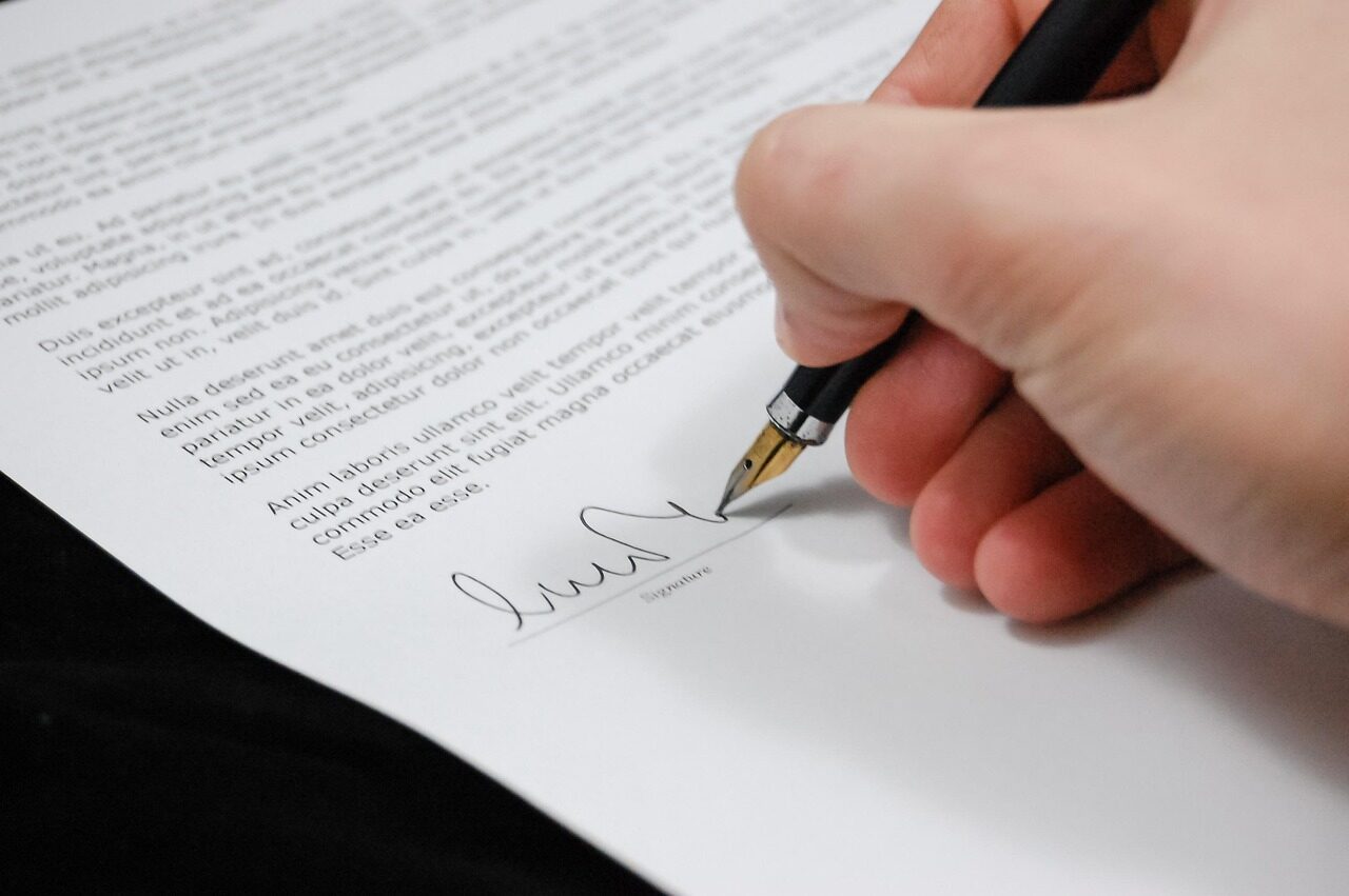 Business documents and a pen on a desk